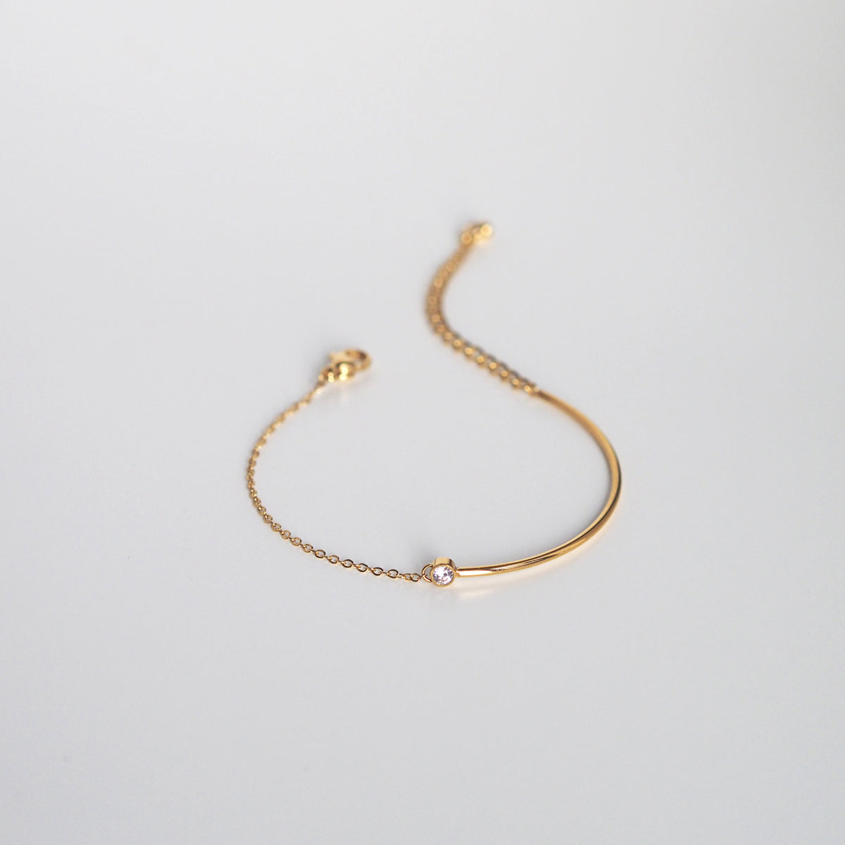 Sleek gold bracelet with a glossy finish and refined modern styling.