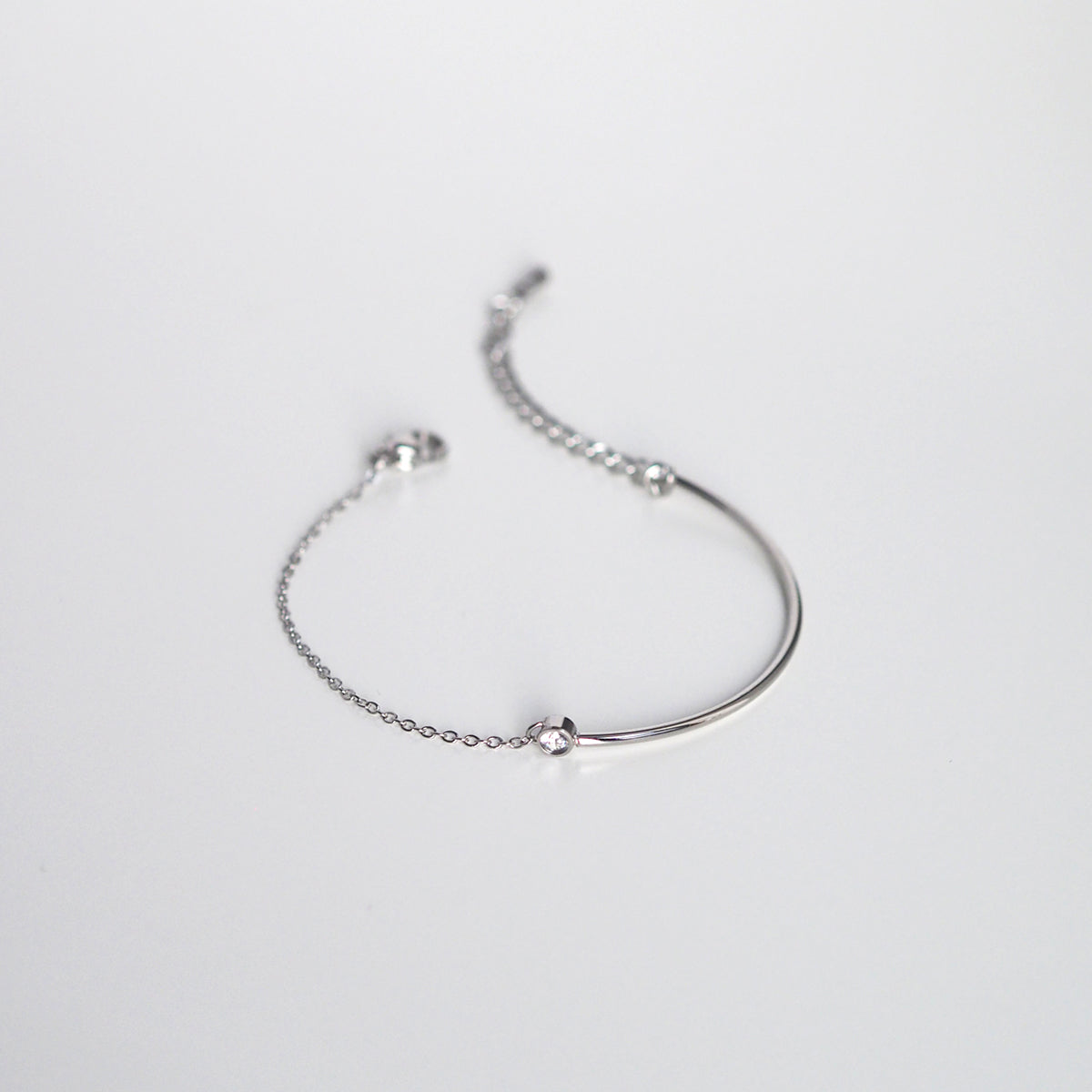 Shiny silver bracelet with minimalist curves and a timeless, elegant feel.