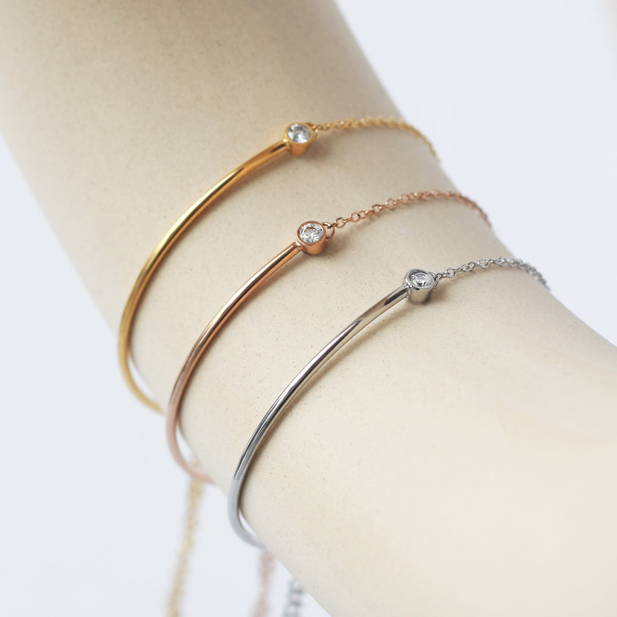 Stylish woman wears the Vera Zirconia Bracelet, featuring a radiant diamond on a sleek band.