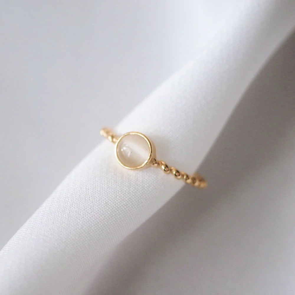 Elegant gold ring with a 6 mm white opal stone, adjustable fit, ideal for daily use and special events.