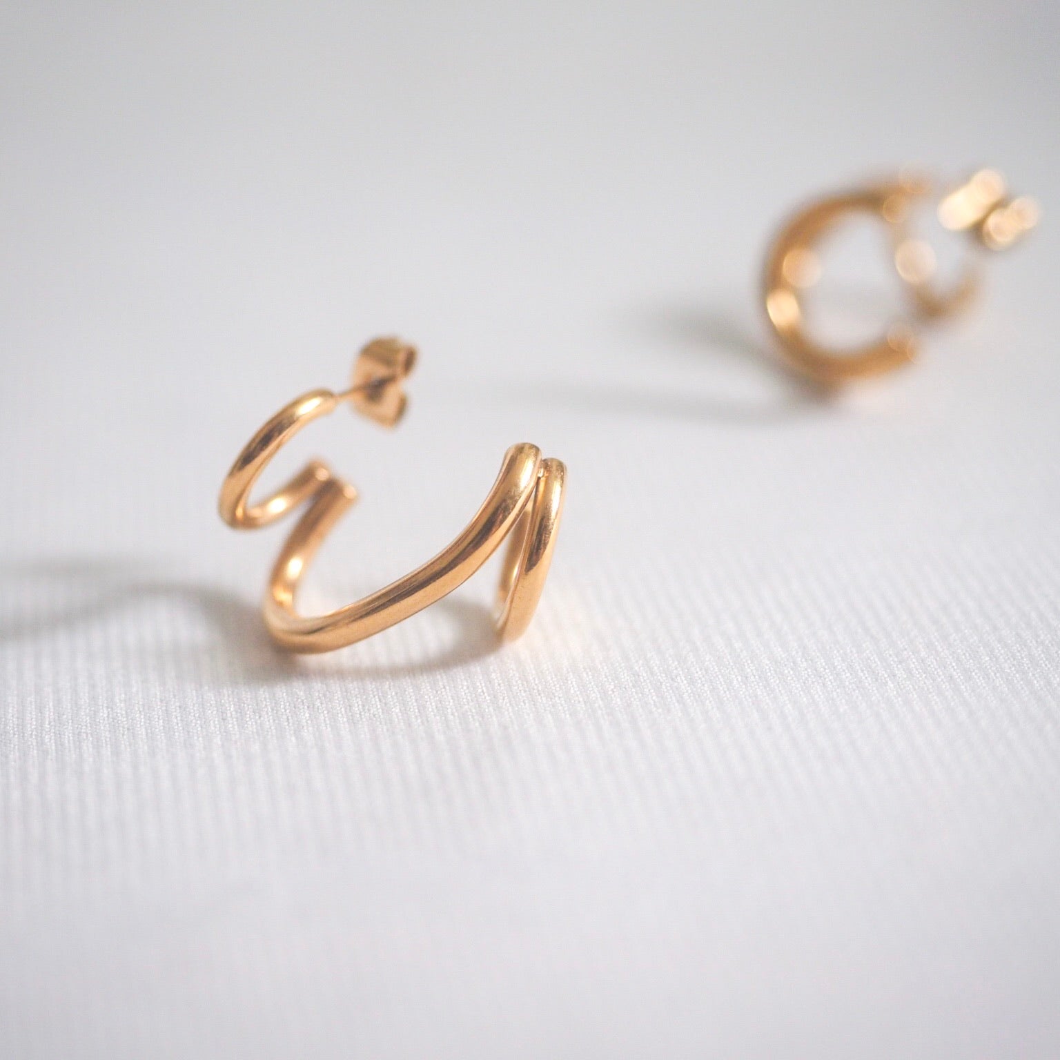 Chic gold-plated earrings adorned with a small heart, designed to elevate your style with a sophisticated flair.