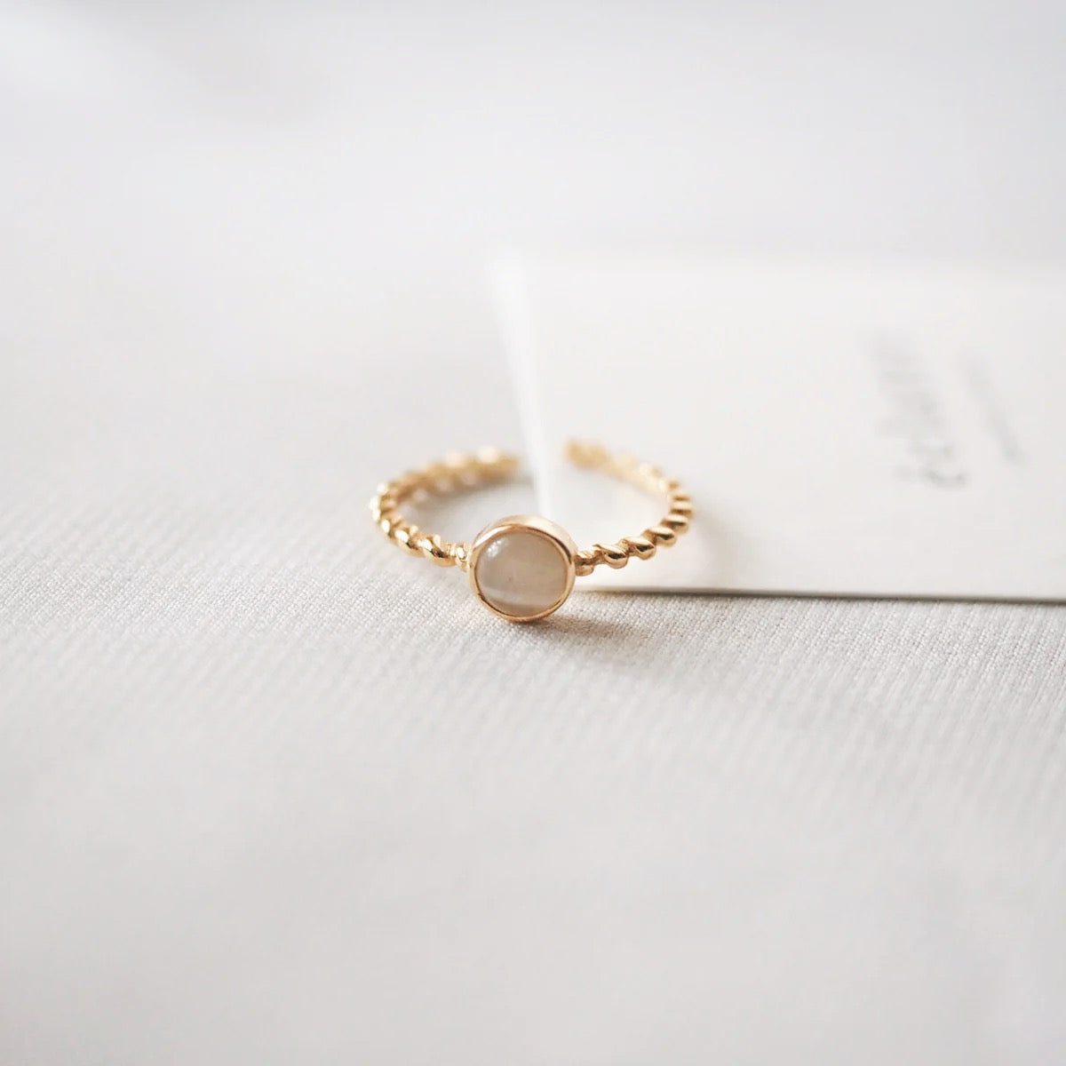 Elegant gold ring with a white opal stone, adjustable fit, ideal for daily use and special events.