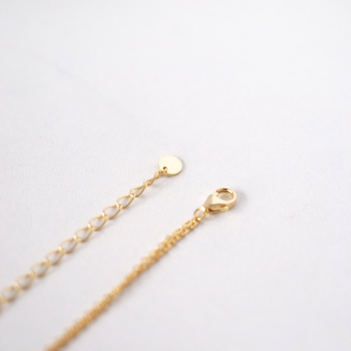Detail shot of the Mone Ball Drop Necklace clasp and adjustable chain extension.