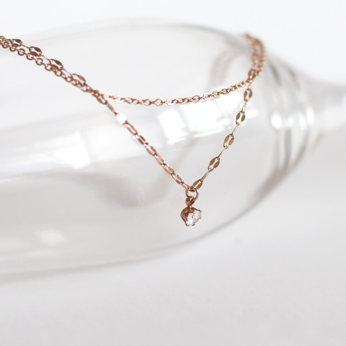 An exquisite rose gold necklace with a tiny crystal, highlighting a refined and sophisticated accessory for any occasion.