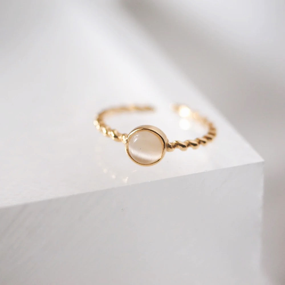 Elegant gold ring with a white opal stone, adjustable fit, ideal for daily use and special events.