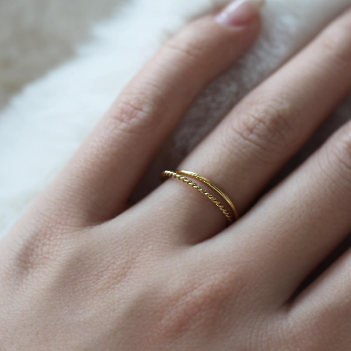 A detailed view of a woman's hand featuring a stunning gold ring, symbolizing beauty and personal expression.