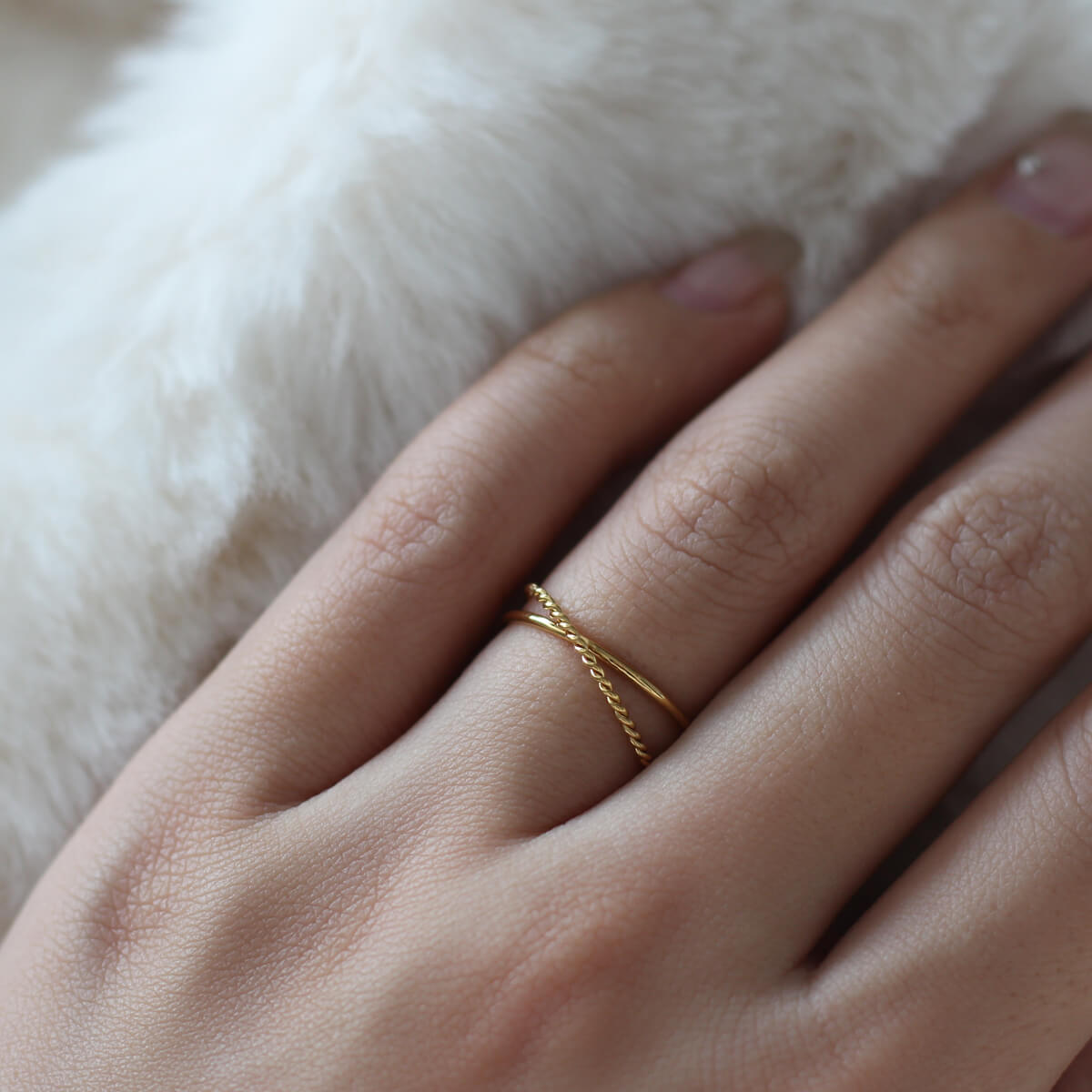 A detailed view of a woman's hand featuring a stunning gold ring, symbolizing beauty and personal expression.