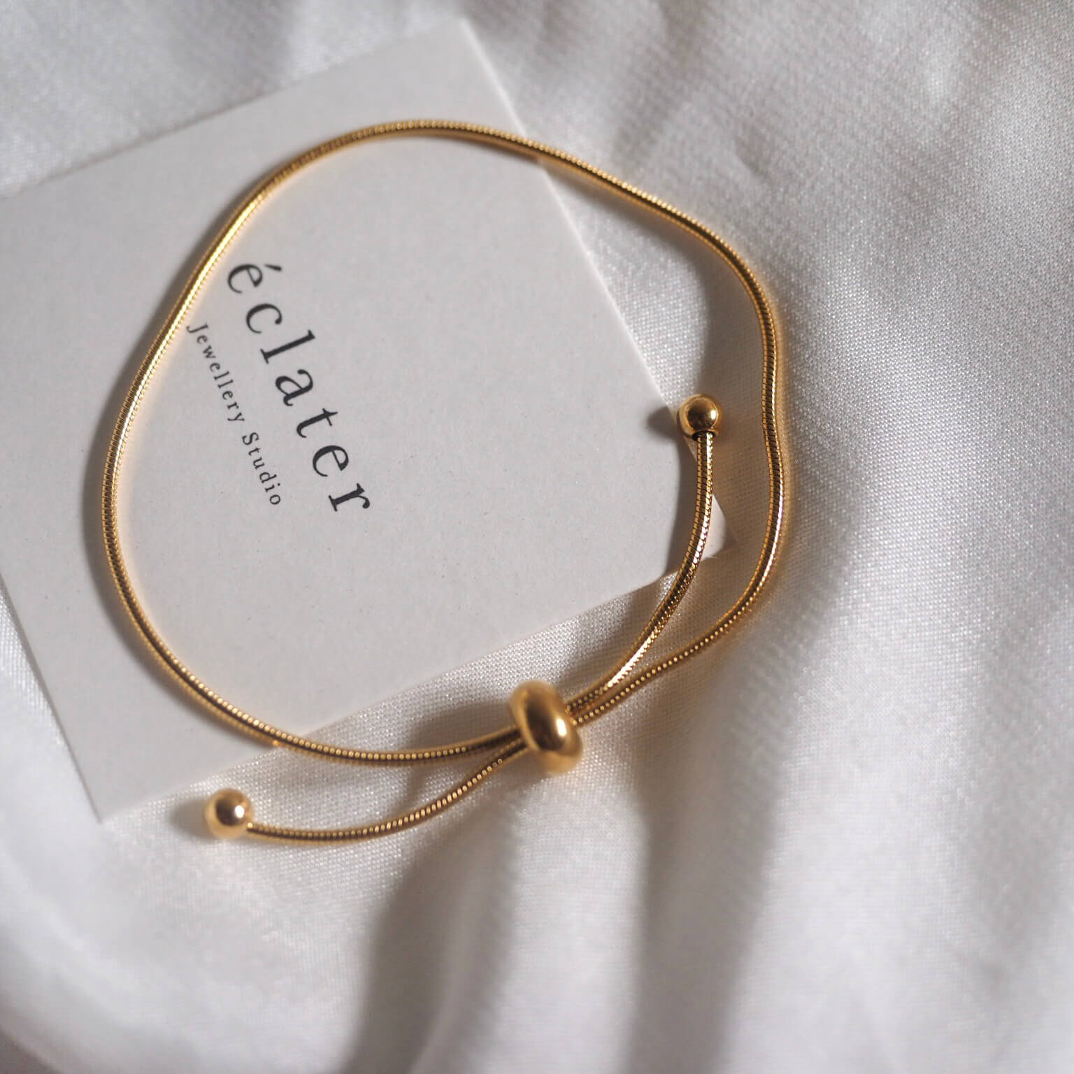 A delicate gold bracelet featuring a charming small ball accent, perfect for adding elegance to any outfit.