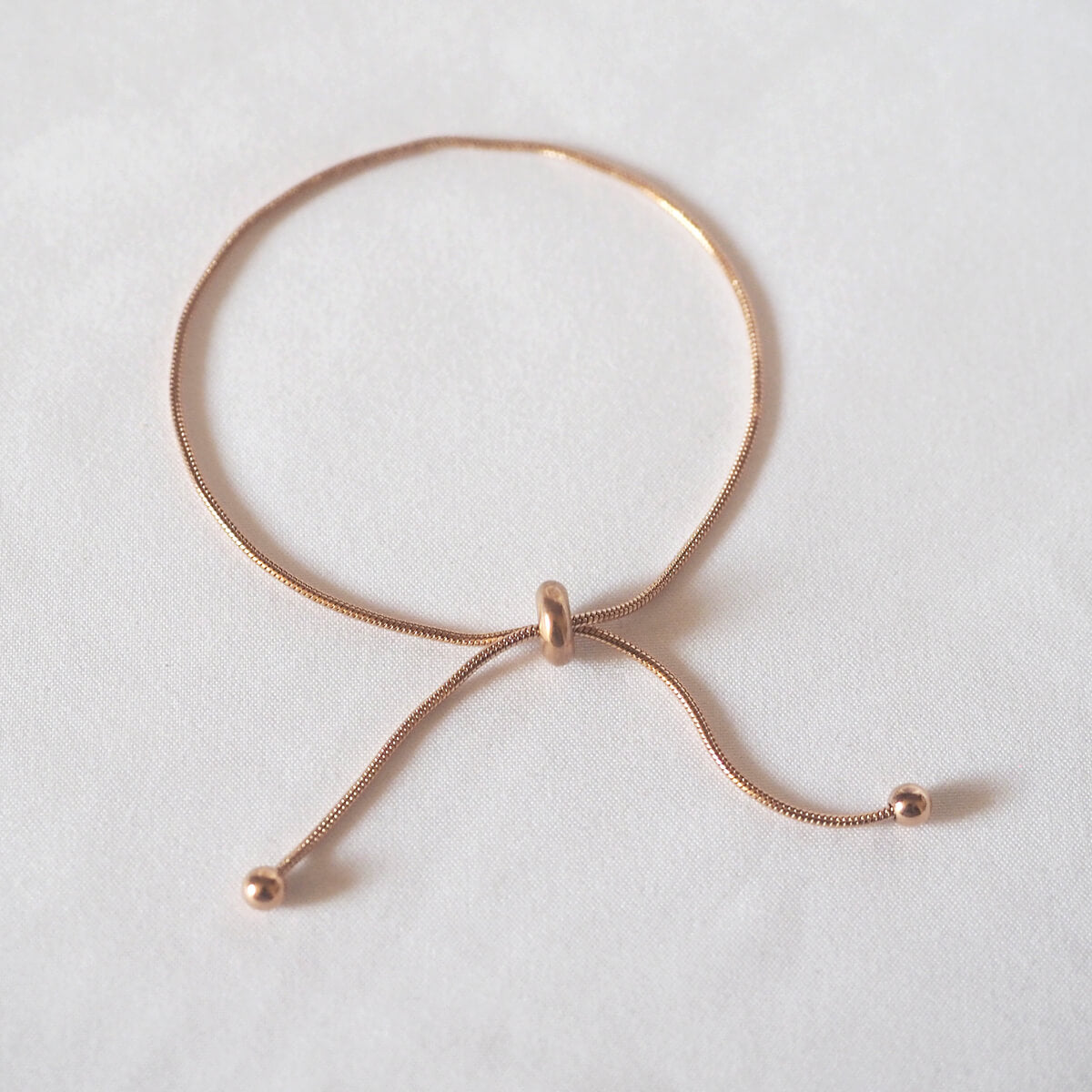 A delicate rose gold bracelet featuring a charming small ball accent, perfect for adding elegance to any outfit.